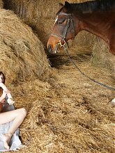 Classy mature slut playing with herself in a barn in front of a horse
